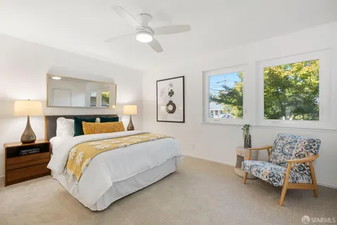 a bedroom with a bed and a couch