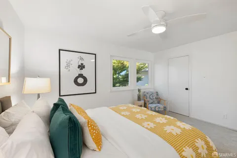 a spacious bedroom with a bed and a chandelier