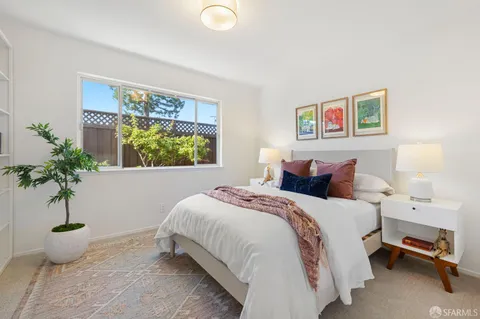 a bedroom with a bed and a painting on the wall