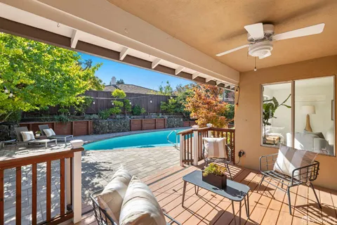 a view of a patio with couches table and chairs and potted plants