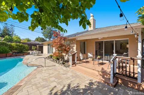 a view of a house with backyard porch and sitting area