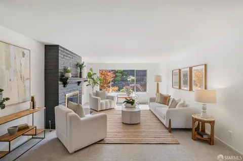 a living room with furniture and a potted plant