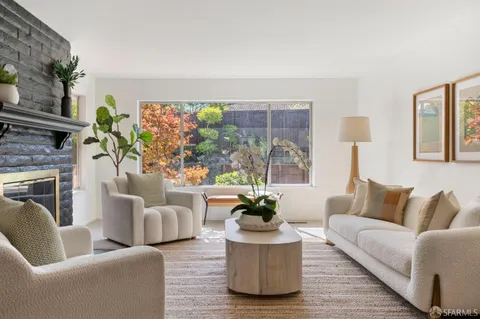 a living room with furniture and a potted plant