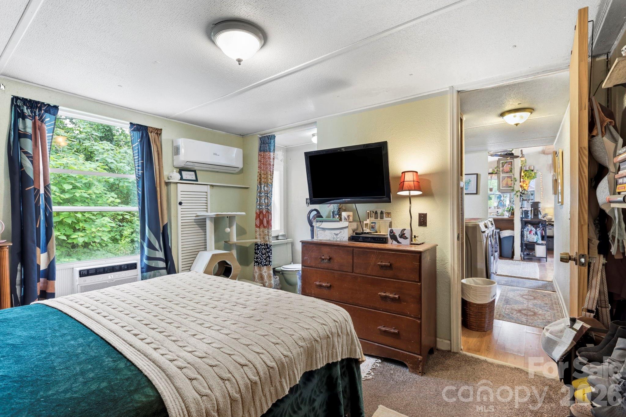 4 Mountain View Road Asheville, NC 28806 - Photo 24 of 35 a bedroom with a bed and a flat screen tv