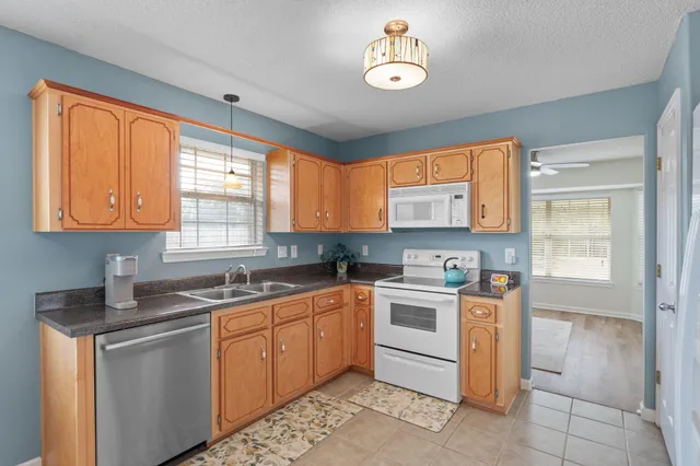 a kitchen with a sink stove and cabinets
