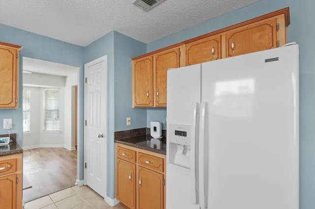 a kitchen with stainless steel appliances a refrigerator and cabinets