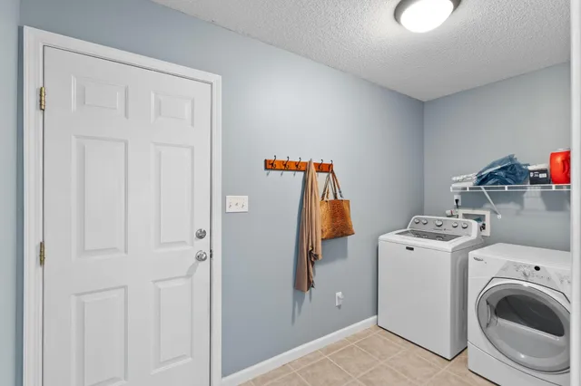 a view of a storage and utility room with washer and dryer