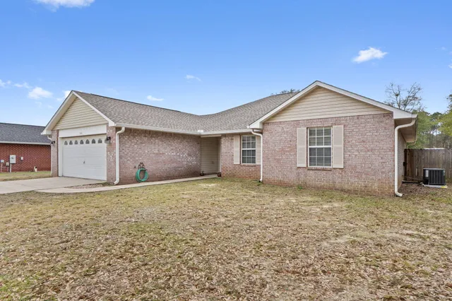 a front door view of a house with a yard