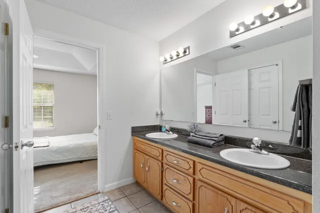 a en suite bathroom with double sink and a mirror