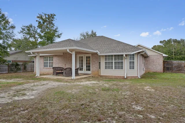 a view of a house with a yard and sitting area