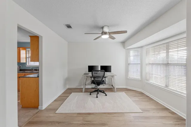 a work room with wooden floor and a window