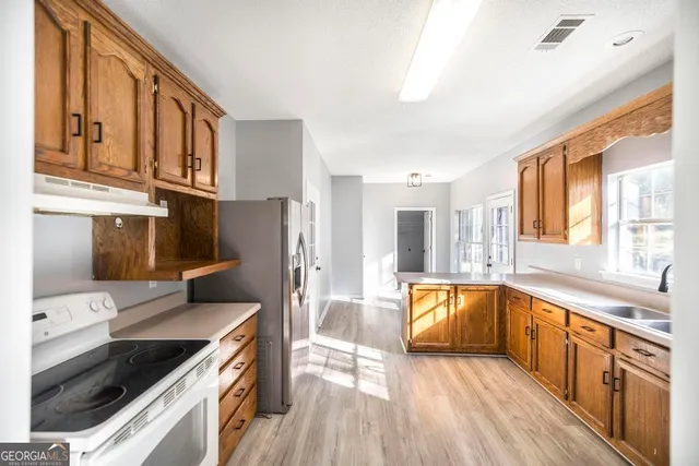 a kitchen with stainless steel appliances granite countertop a stove and a sink