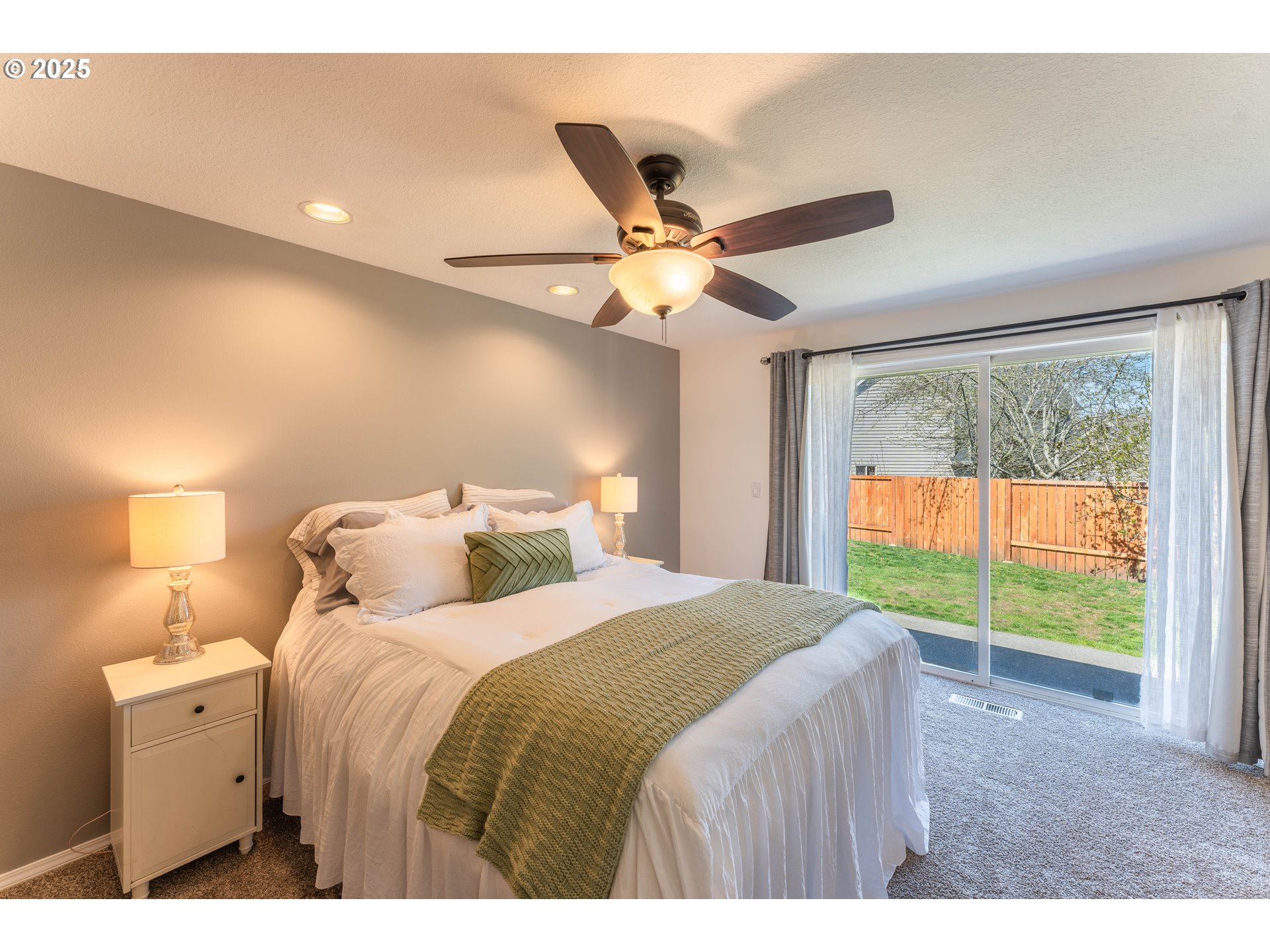 3983 Southeast 30th Street Gresham, OR 97080 - Photo 16 of 34 a bedroom with a large bed and a chandelier