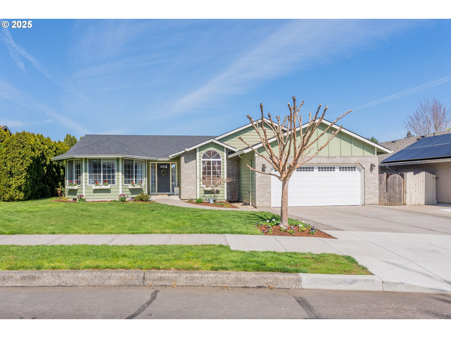 3983 Southeast 30th Street Gresham, OR 97080 - Photo 2 of 34 a front view of a house with a garden and yard