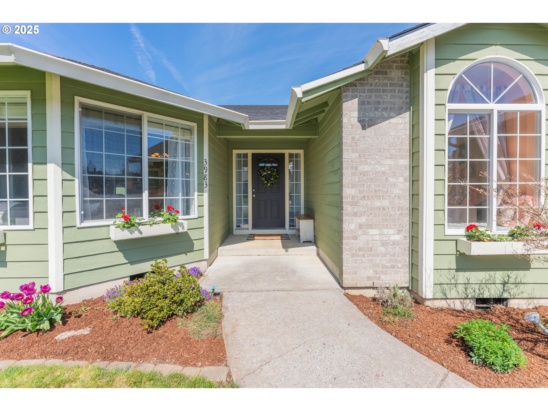 3983 Southeast 30th Street Gresham, OR 97080 - Photo 3 of 34 a front view of a house with a garden
