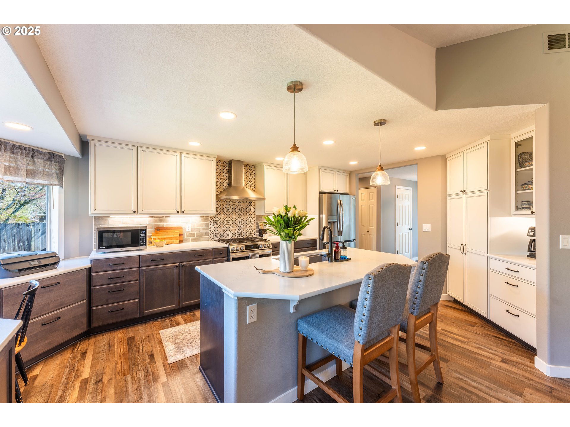 3983 Southeast 30th Street Gresham, OR 97080 - Photo 8 of 34 a kitchen with stainless steel appliances kitchen island granite countertop a dining table chairs and white cabinets