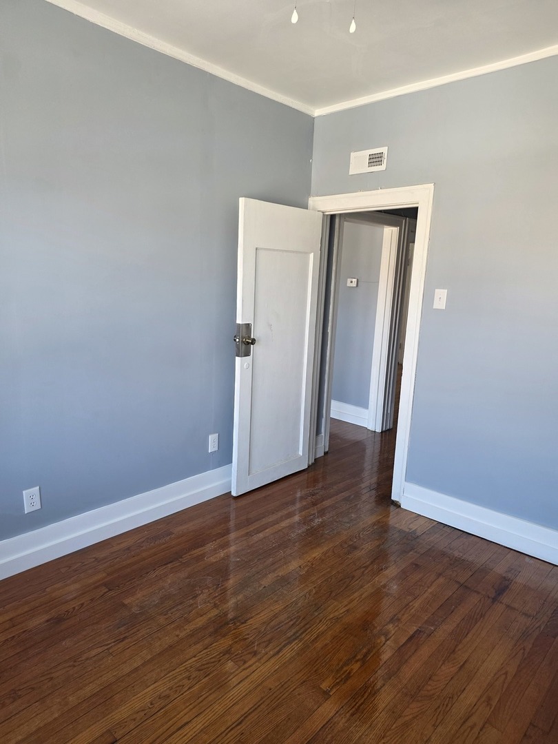 1853 East 79th Street, Unit 2 Chicago, IL 60649 - Photo 5 of 14 a view of a room with wooden floor
