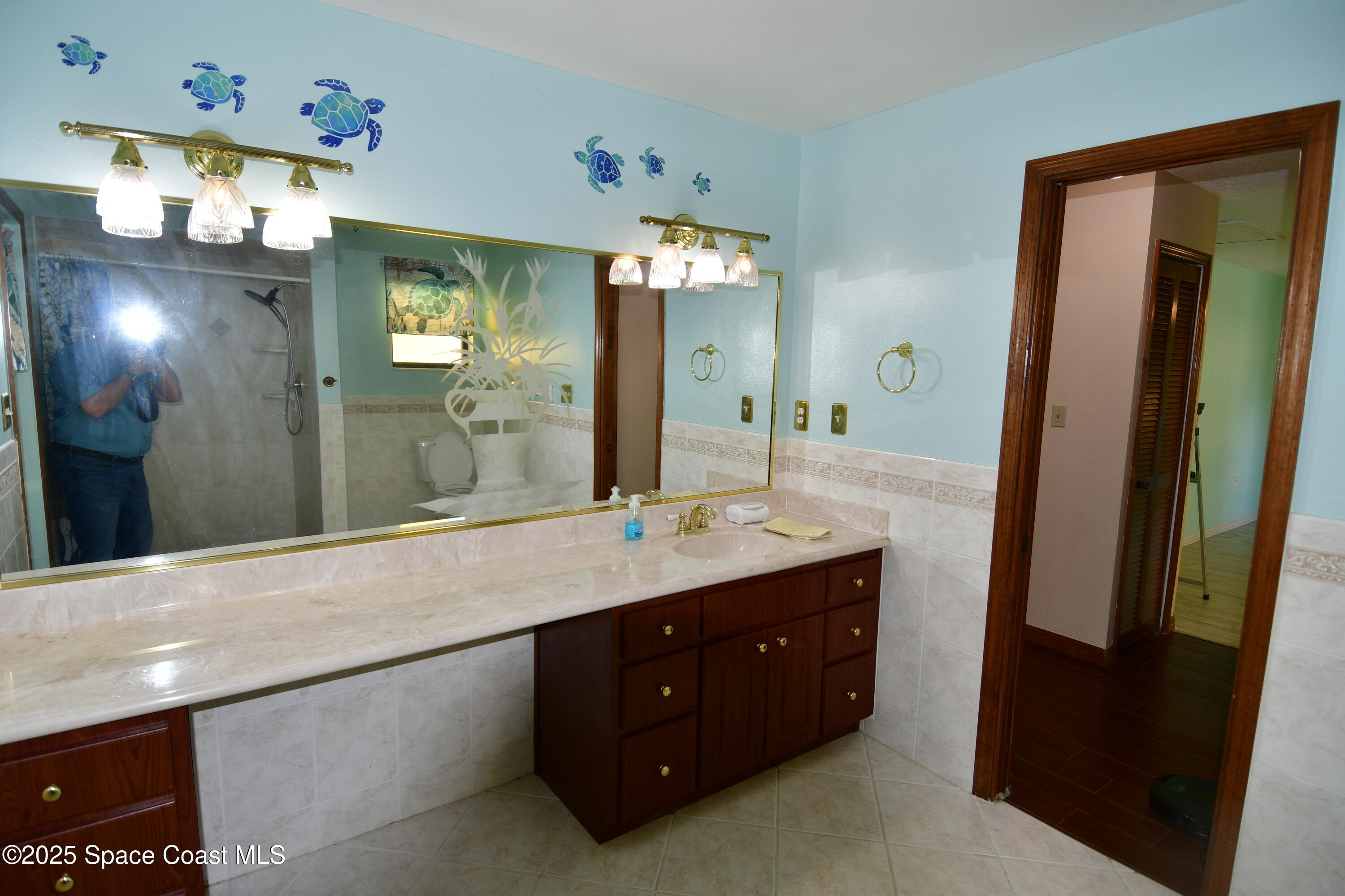 4501 Seattle Street Cocoa, FL 32927 - Photo 9 of 13 a bathroom with a sink double vanity and a mirror