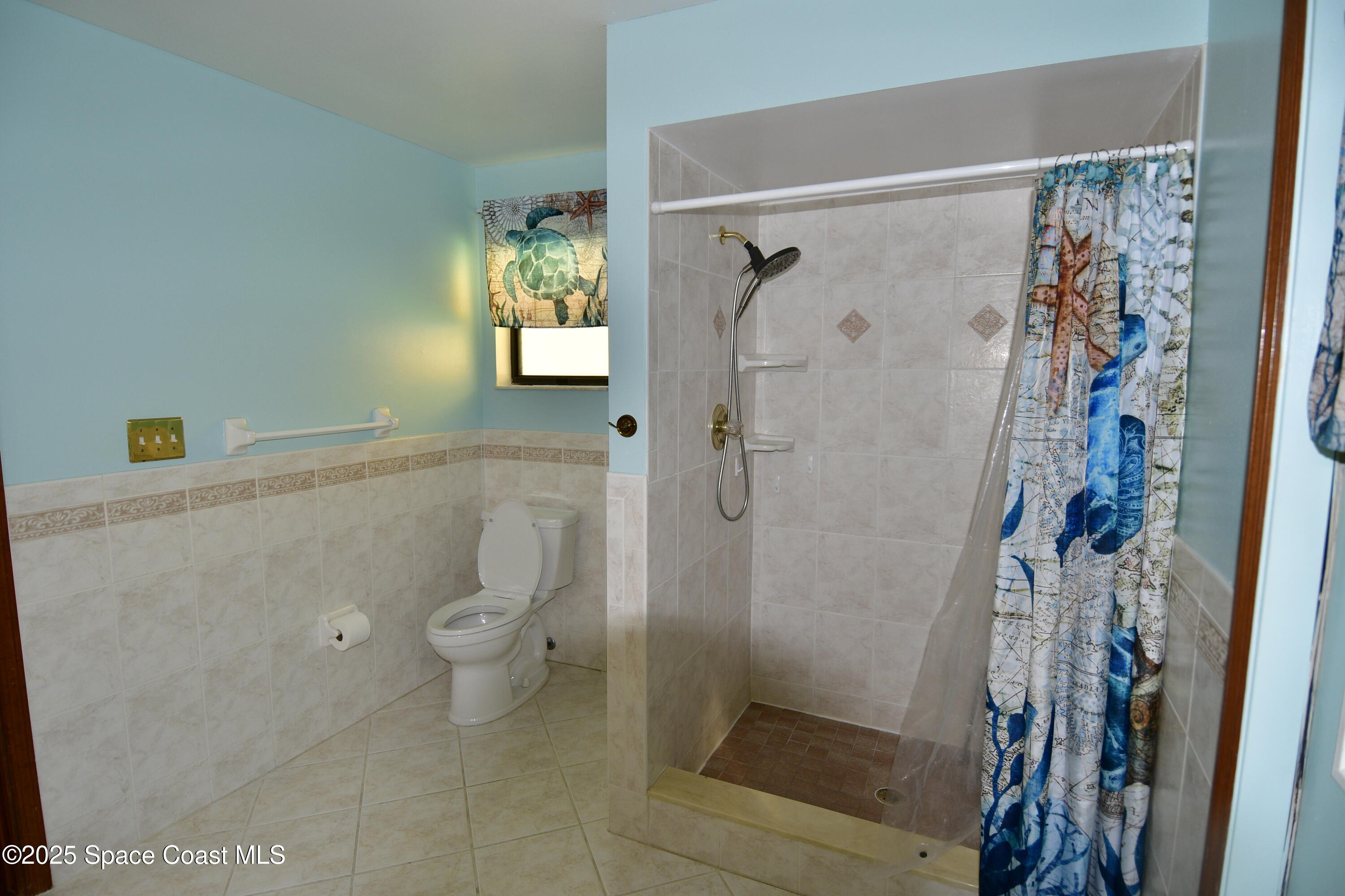 4501 Seattle Street Cocoa, FL 32927 - Photo 10 of 13 a bathroom with a shower toilet and sink