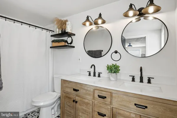 a bathroom with a toilet a sink and a mirror