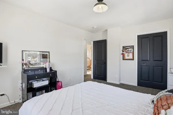 a bedroom with a bed and a desk