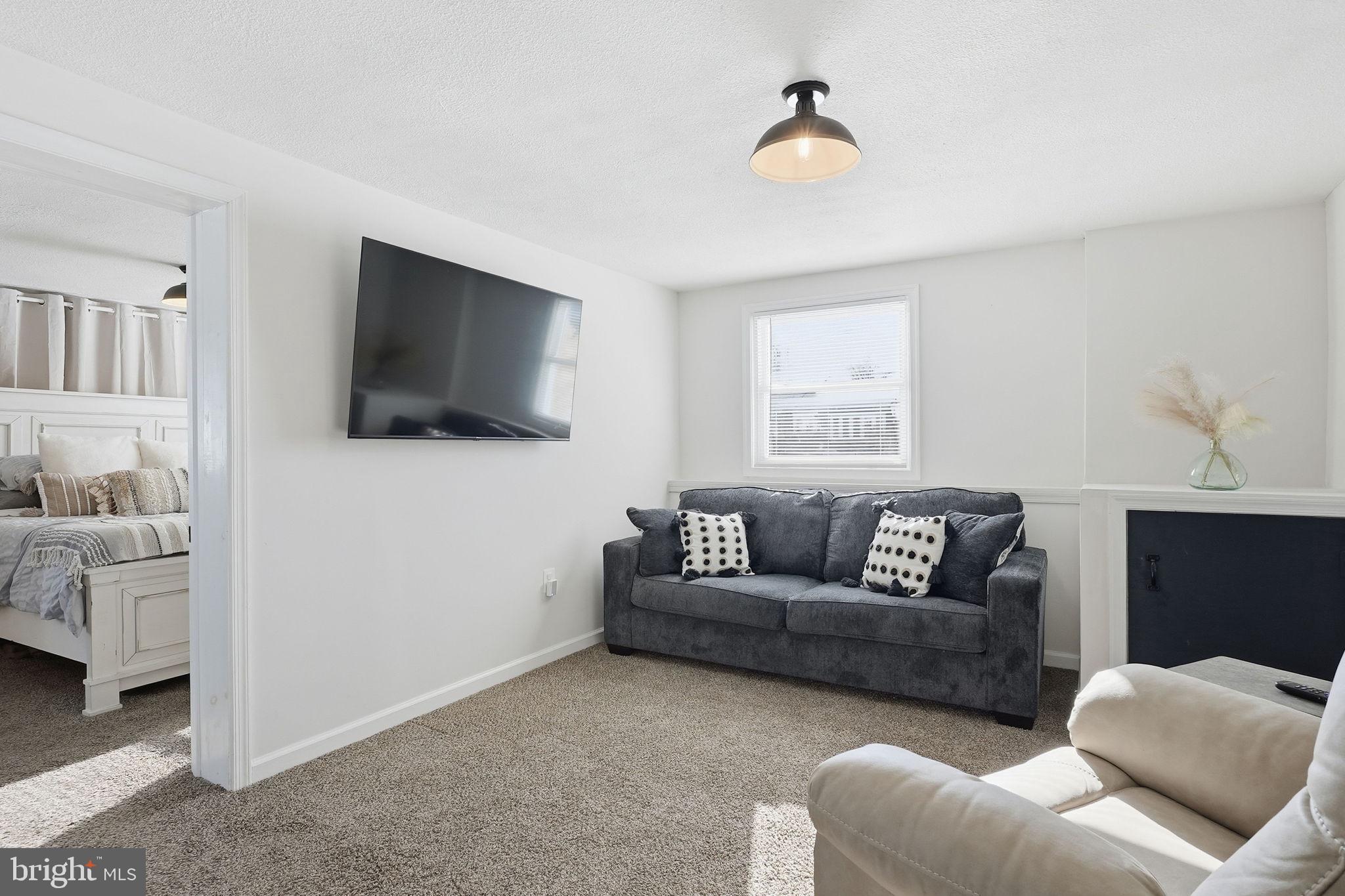 105 Michael Avenue Linthicum Heights, MD 21090 - Photo 9 of 24 a living room with furniture and a flat screen tv