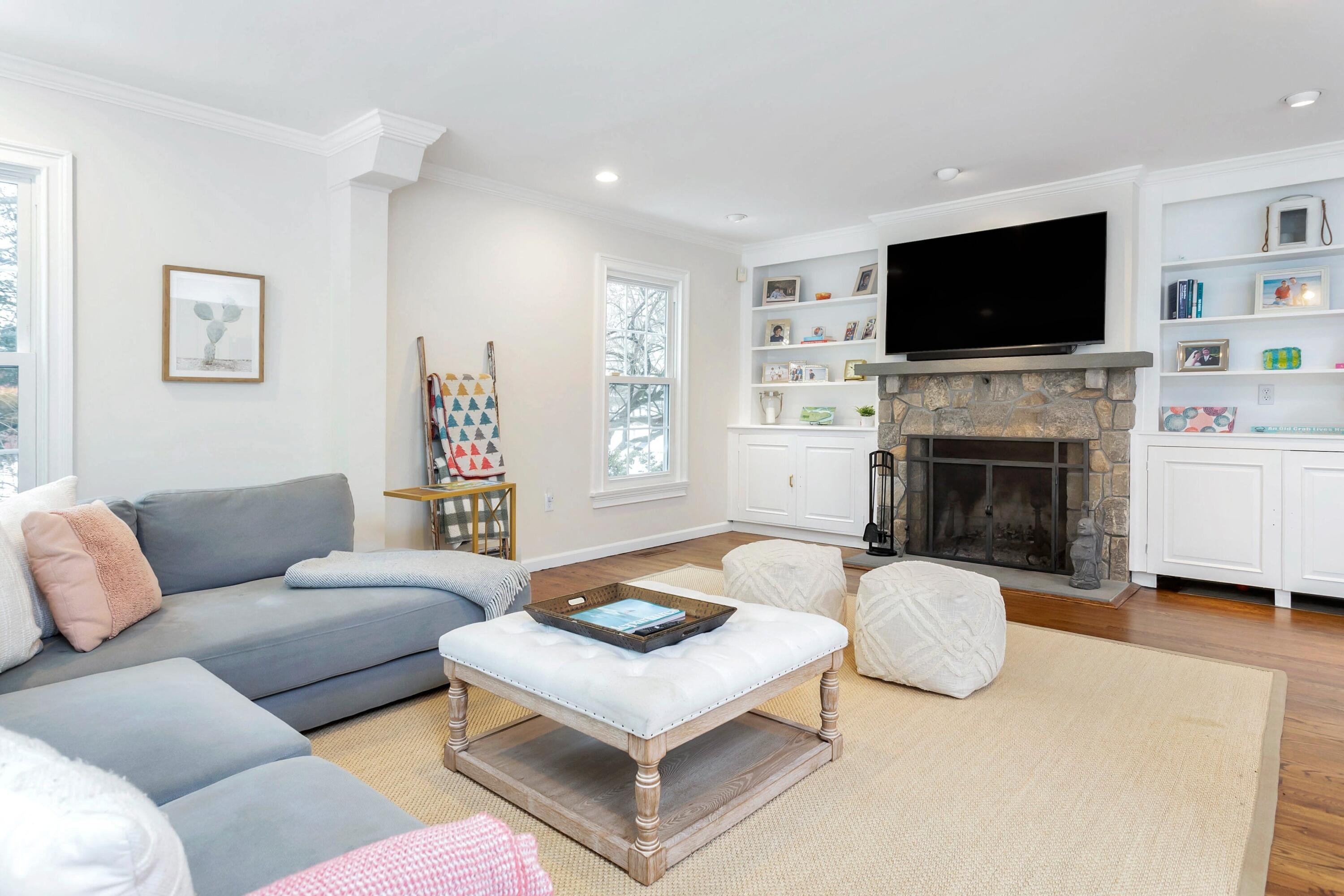 2 Red Barn Road Darien, CT 06820 - Photo 16 of 38 a living room with furniture flat screen tv and a fireplace