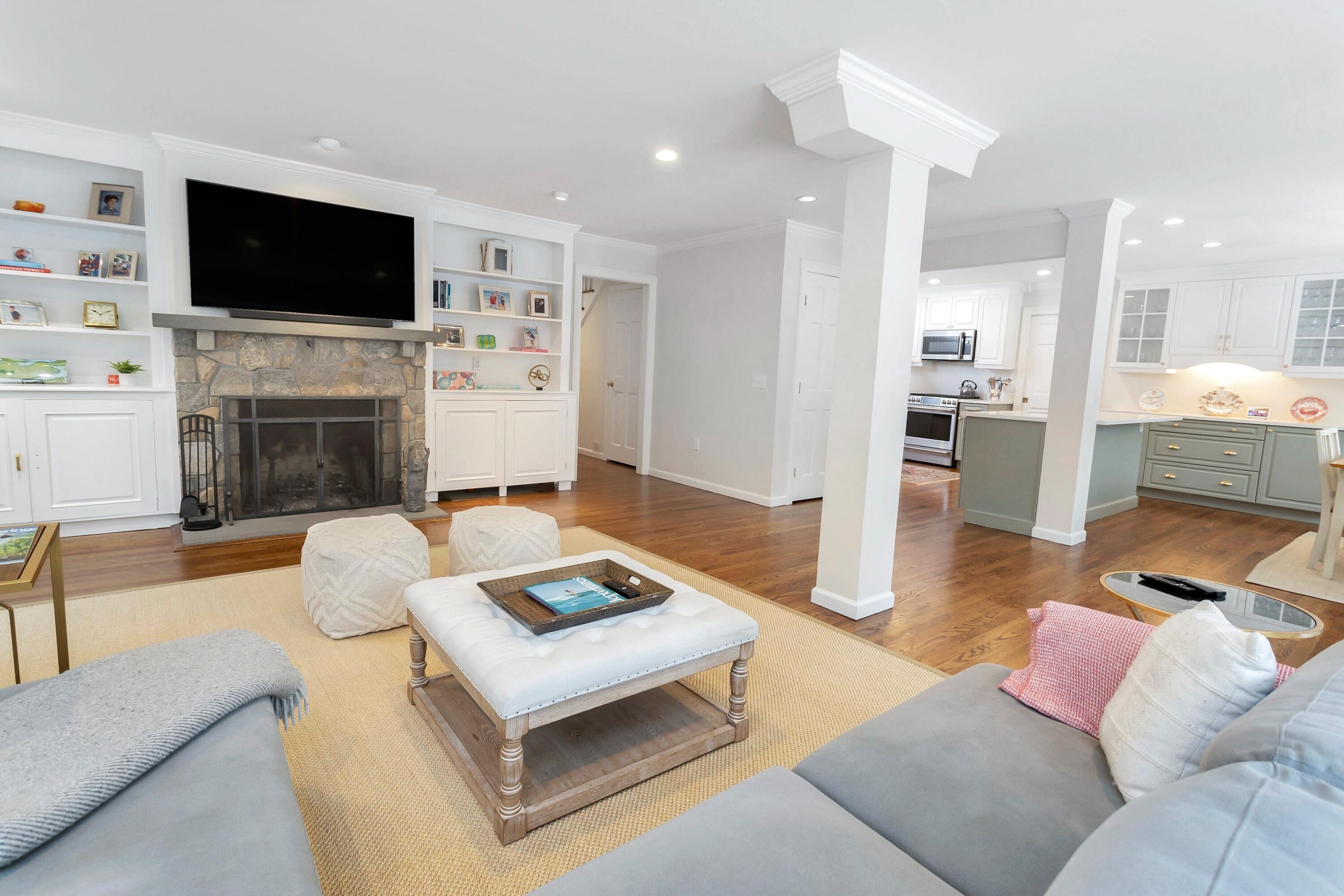 2 Red Barn Road Darien, CT 06820 - Photo 17 of 38 a living room with furniture a fireplace and a flat screen tv