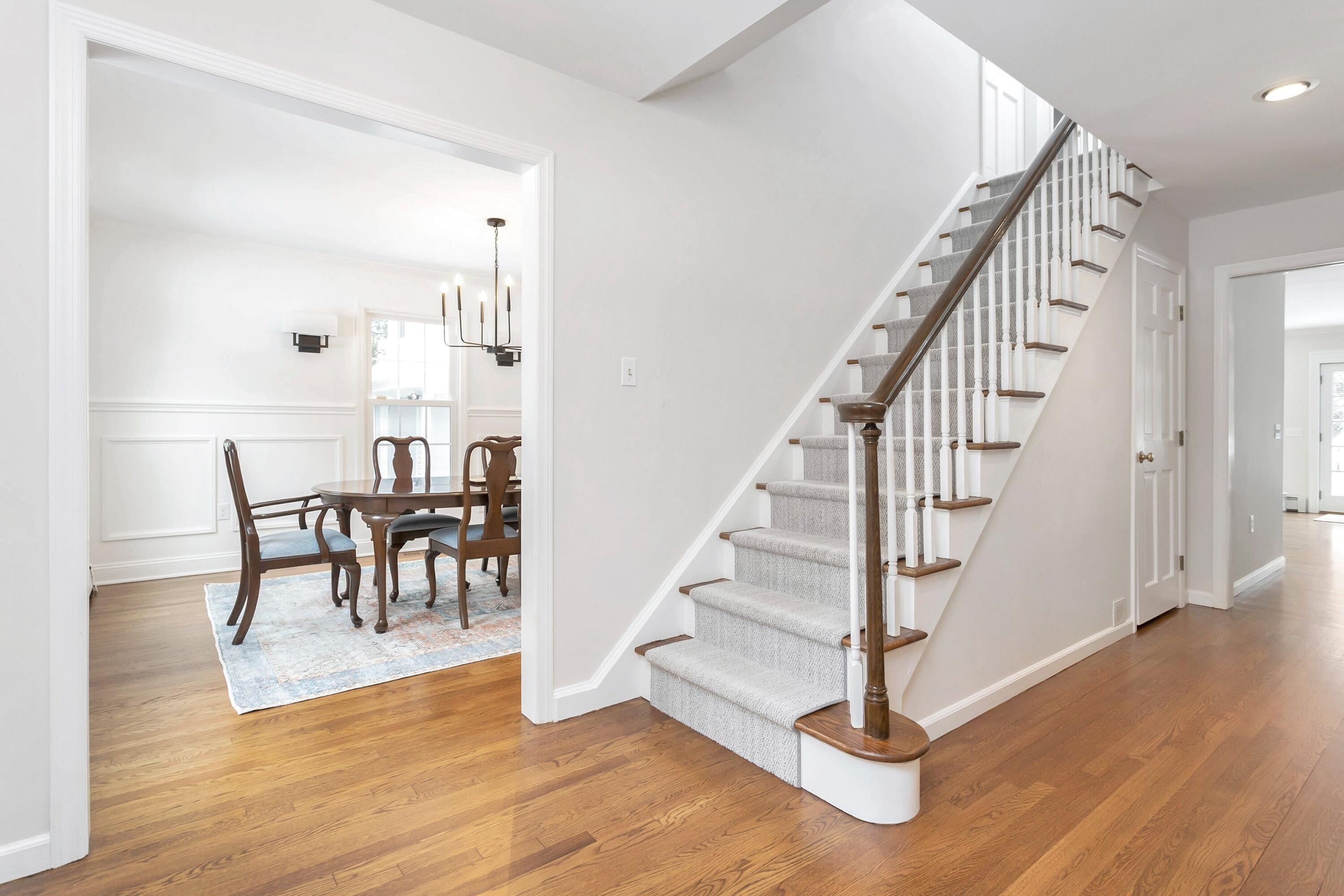 2 Red Barn Road Darien, CT 06820 - Photo 3 of 38 a view of a hallway with wooden floor and dining room