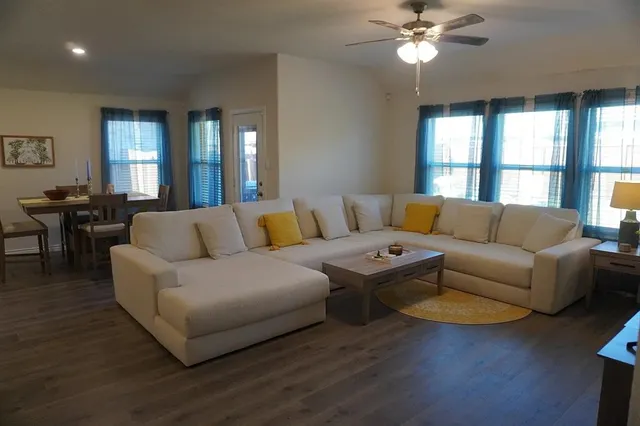 a living room with furniture and a large window