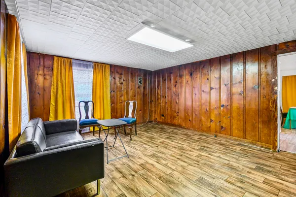 a living room with furniture and large window