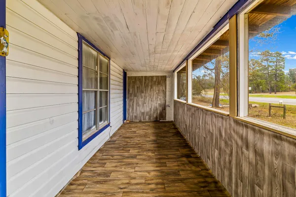 a view of a porch with wooden floor and stairs