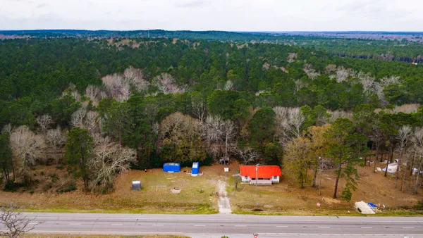 an aerial view of a house swimming pool a yard and mountain view