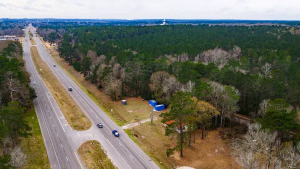 a view of a floor to ceiling window and a yard