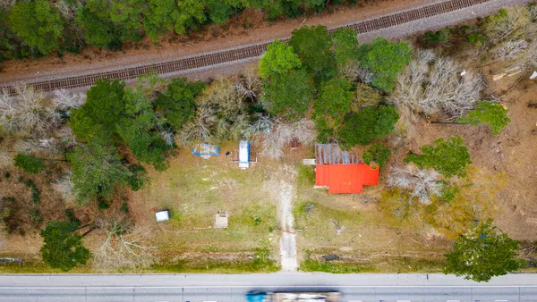 a view of a lake with a floor to ceiling window and balcony