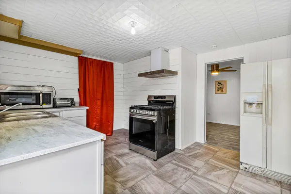 a kitchen with stainless steel appliances granite countertop a stove and a refrigerator