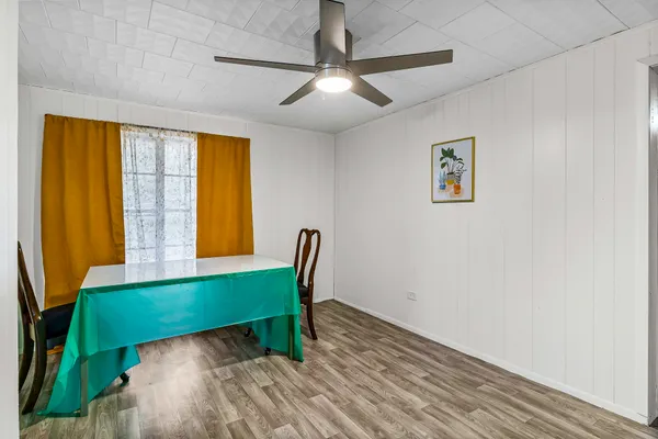 a view of a dining room with furniture and a window