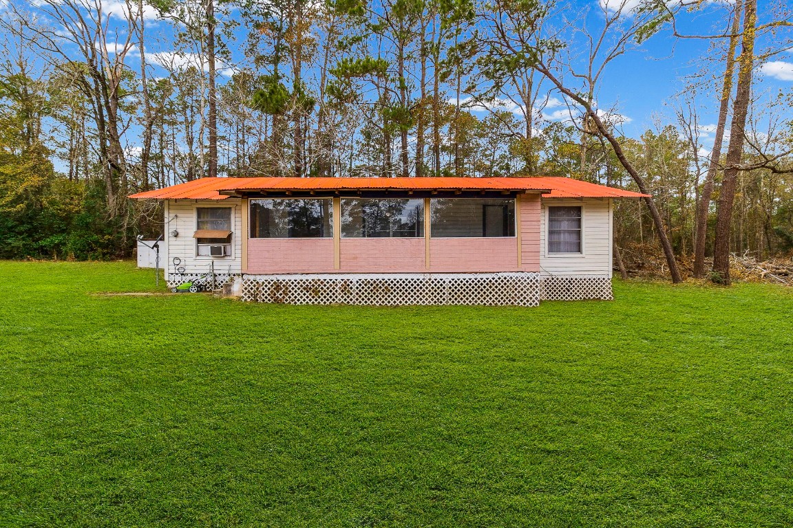 24103 Highway 59 Corrigan, TX 75939 - Photo 7 of 27 a front view of a house with a garden