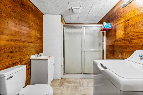 a bathroom with a toilet and a shower