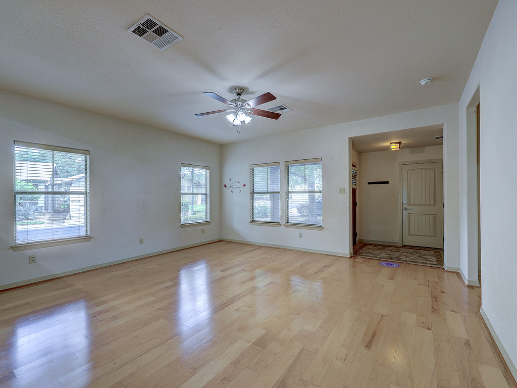 9707 Anderson Mill Road, Unit 22 Austin, TX 78750 - Photo 12 of 39 A naturally illuminated living area featuring gleaming hardwood floors and ample window light.