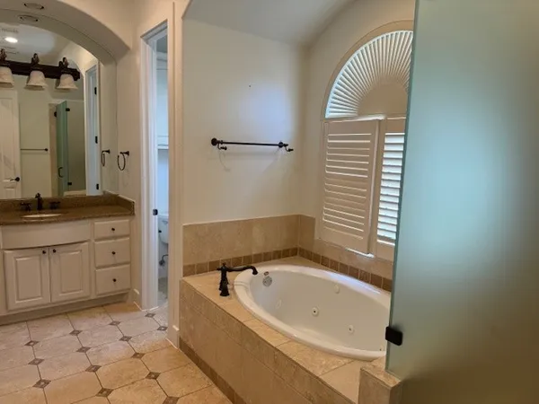 a bathroom with a bathtub and a sink