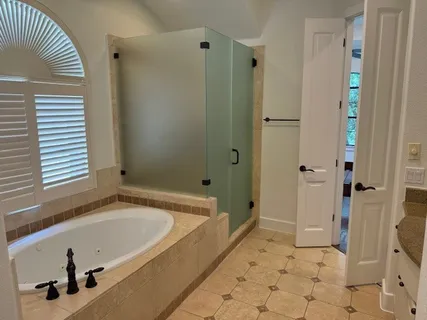a bathroom with a tub and a shower