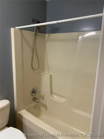 a bathroom with a shower and a toilet