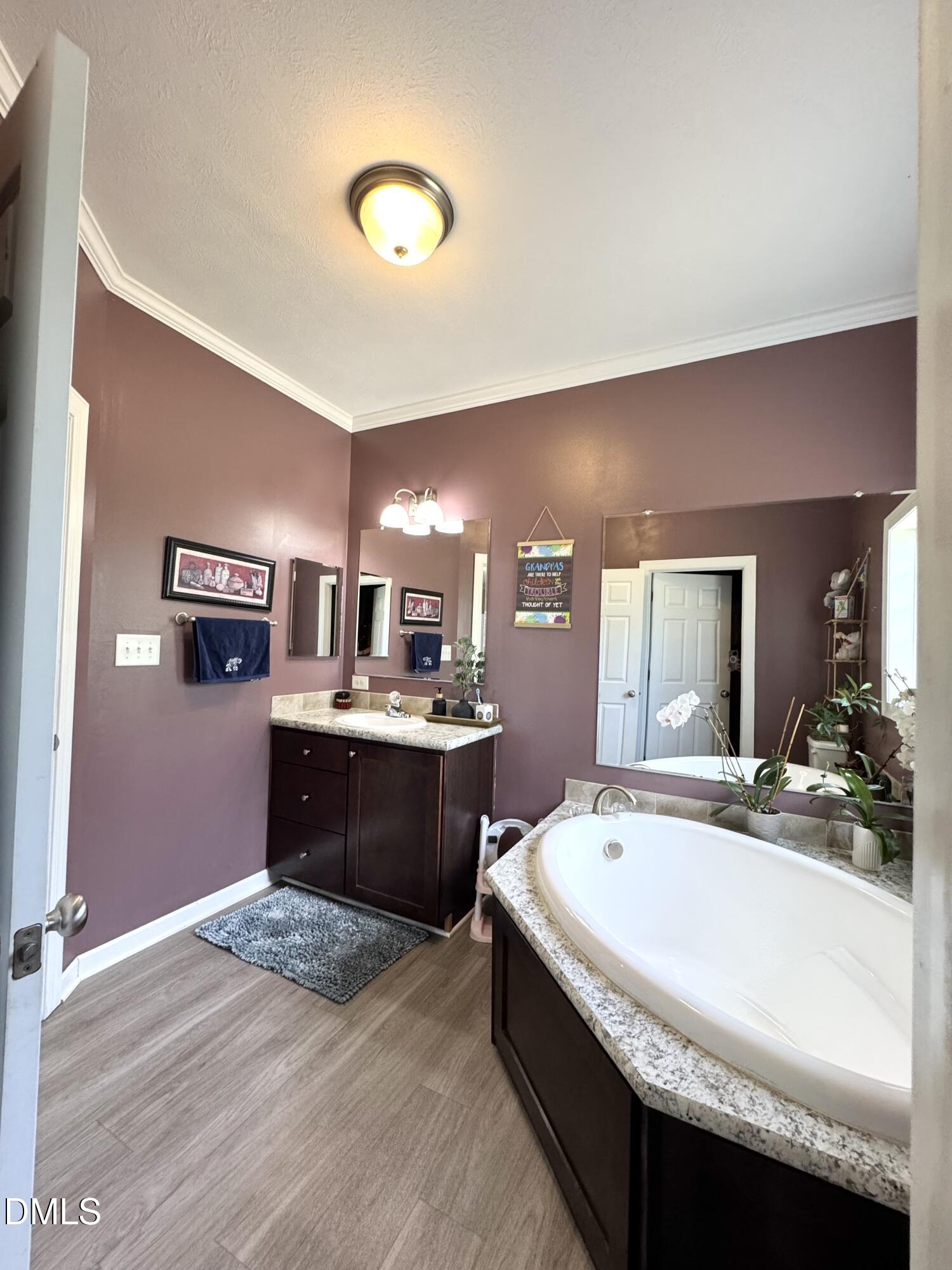 640 Tart Town Road Dunn, NC 28334 - Photo 35 of 71 a spacious bathroom with a tub double vanity and a sink