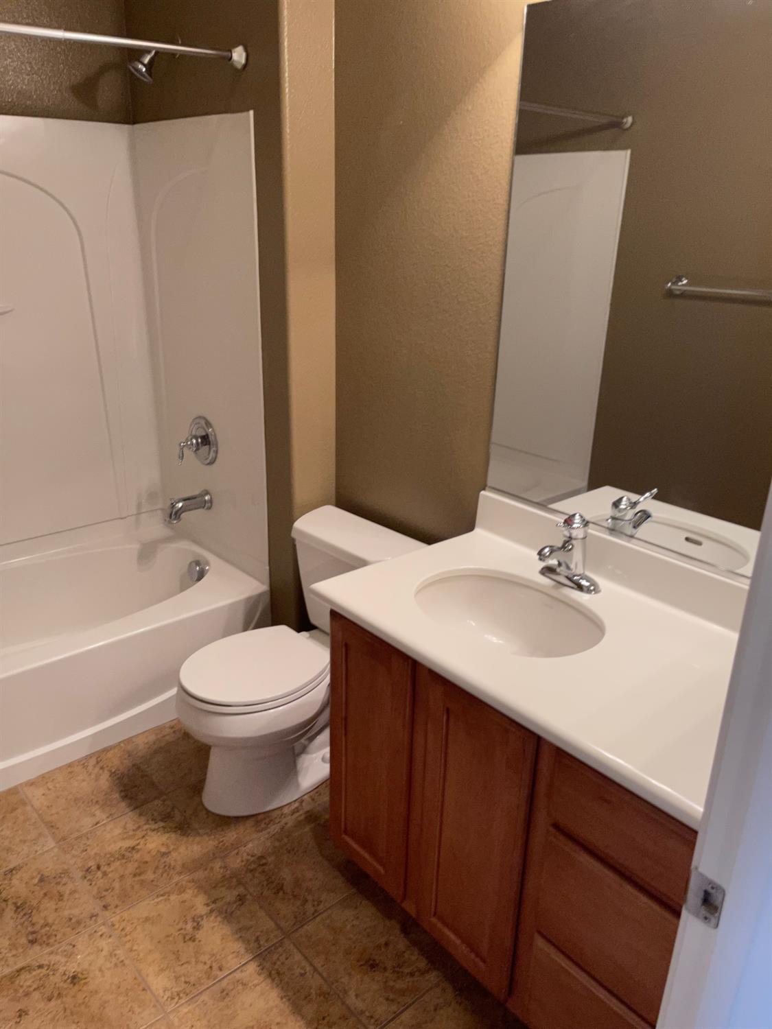 72 South Rio Rapido Drive Tracy, CA 95391 - Photo 12 of 24 a bathroom with a sink a toilet and shower