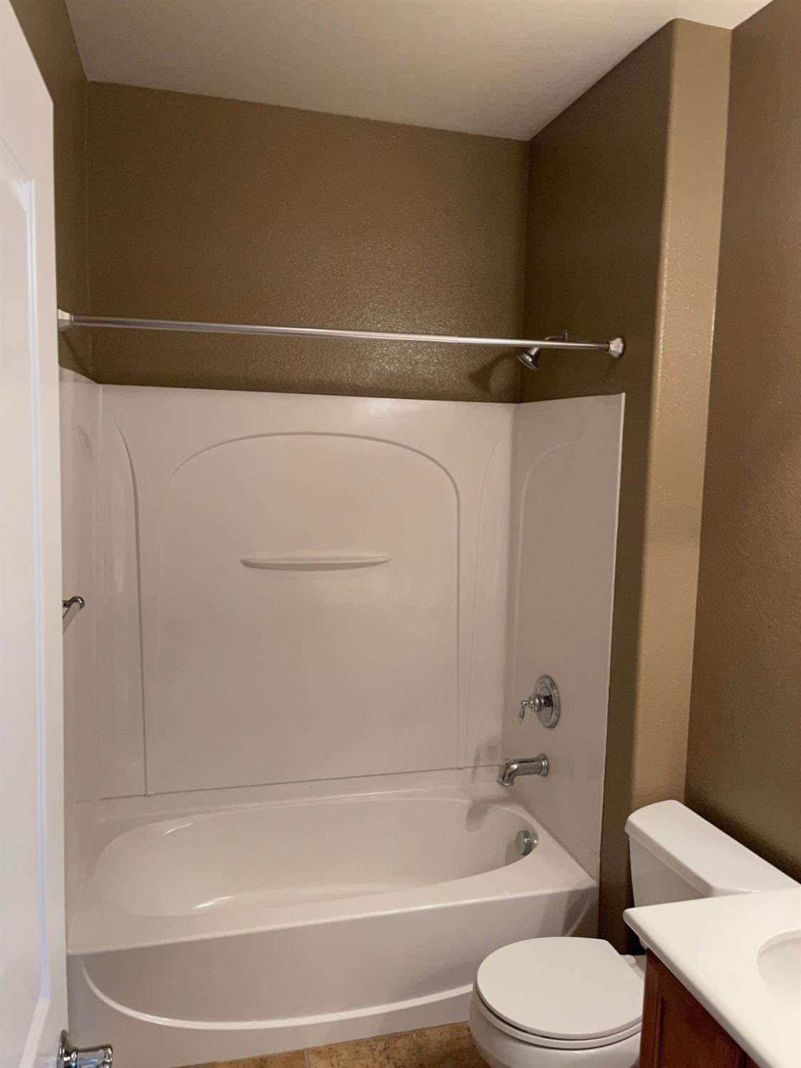 72 South Rio Rapido Drive Tracy, CA 95391 - Photo 18 of 24 a bathroom with a shower and a toilet