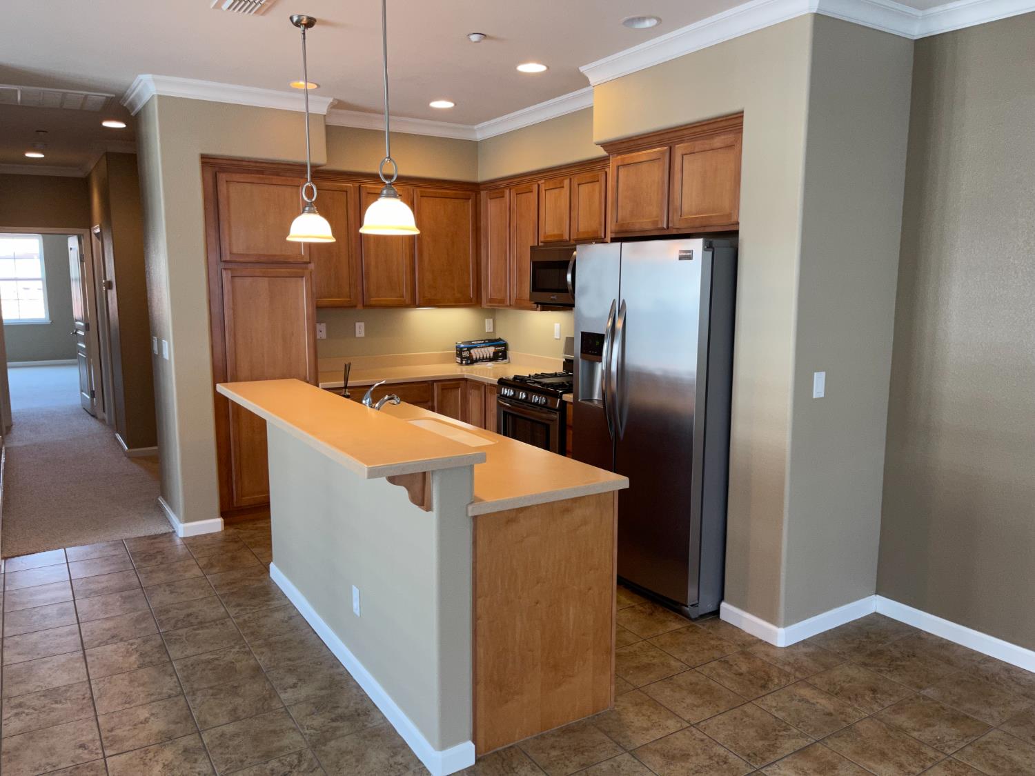 72 South Rio Rapido Drive Tracy, CA 95391 - Photo 6 of 24 a kitchen with stainless steel appliances granite countertop a refrigerator a oven and a sink with wooden floor