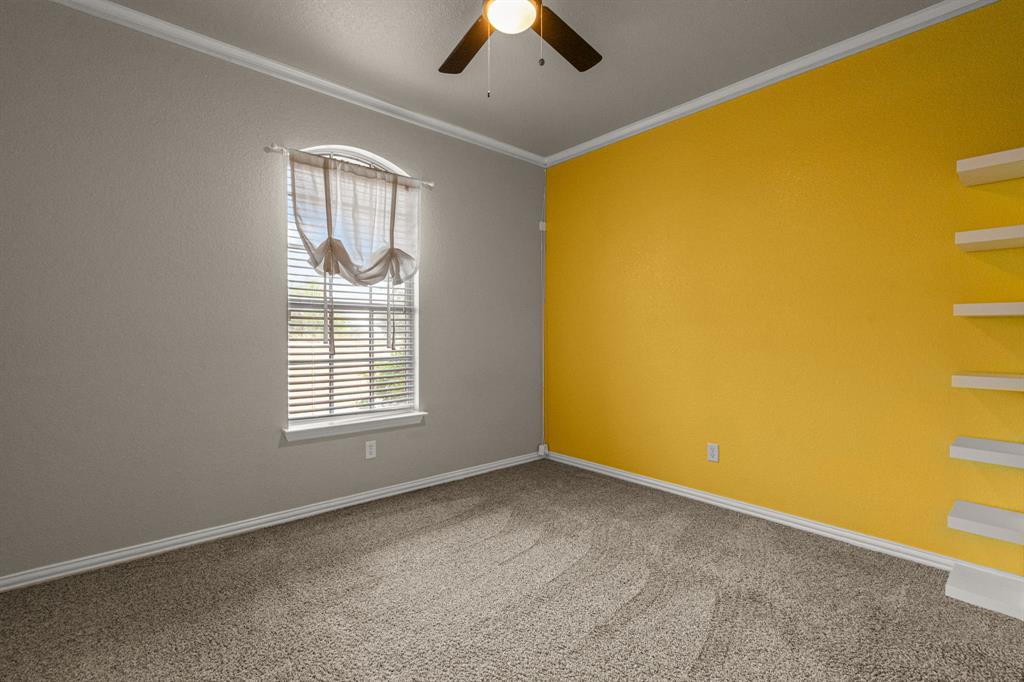 6501 Indian Trail Sanger, TX 76266 - Photo 9 of 39 Unfurnished room with ornamental molding, light colored carpet, and a ceiling fan