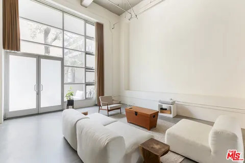 a bedroom with furniture and a large window