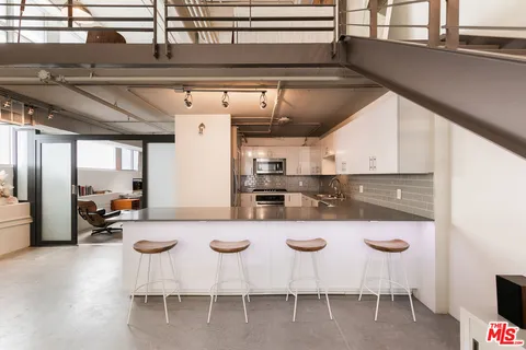 a kitchen with a table chairs stove and kitchen island